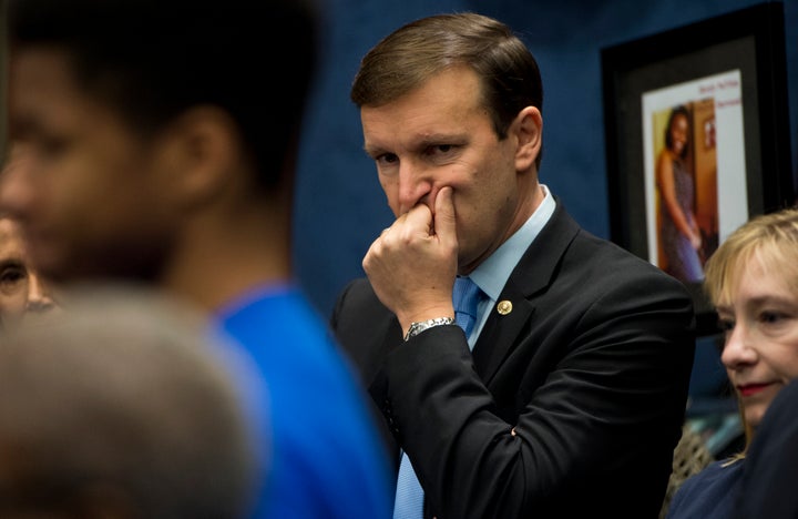 Sen. Chris Murphy listens as families of gun violence victims tell their stories in December 2015 during an event in the U.S.