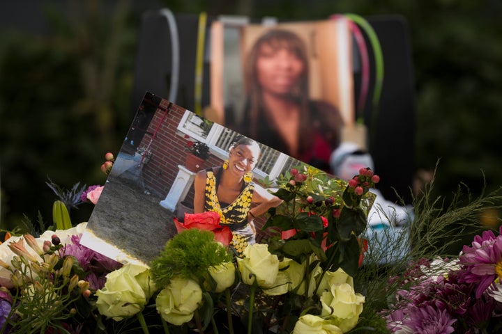 Flowers, photos and other items are placed at a memorial for Charleena Lyles at the Seattle apartment building where she was killed earlier this month.