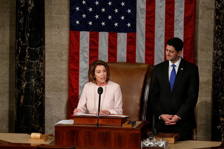 House Speaker Paul Ryan (R-Wis.) listens to House Democratic Leader Nancy Pelosi (D-Calif.) during the opening session of the
