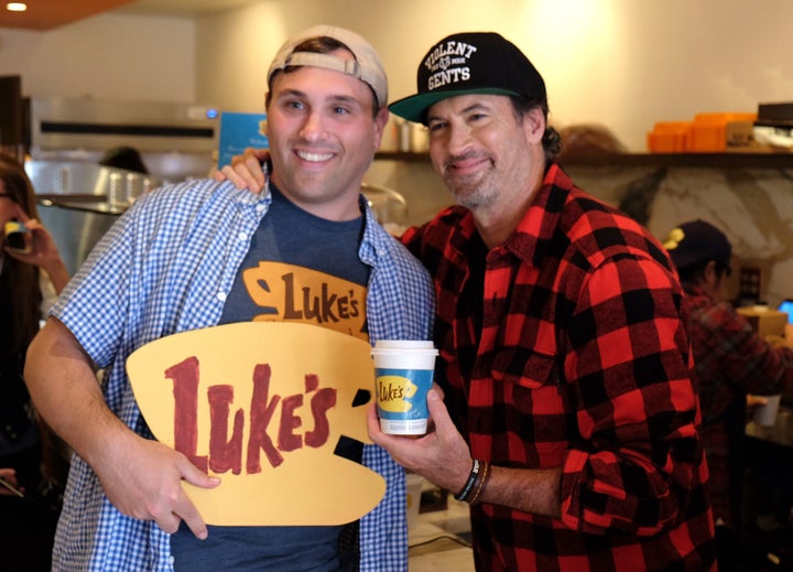 Scott Patterson holding a cup of Luke's coffee.