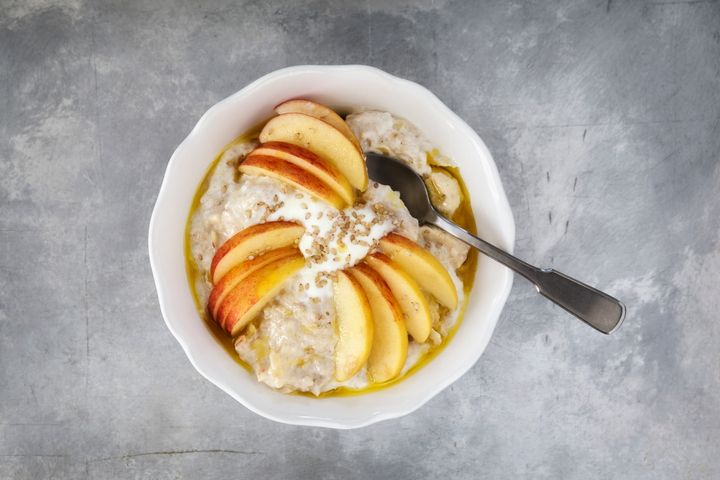 Bowl with porridge, apples, banana and sesame seeds Tuned_In via Getty Images