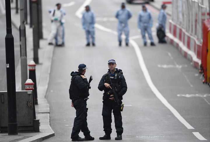<strong> Armed police officers patrol London Bridge the day after the attack</strong>