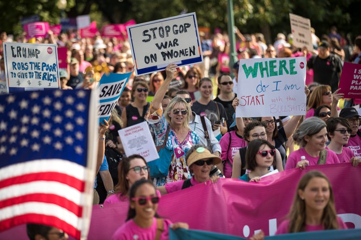 Activists march around the U.S. Capitol to protest the Senate GOP health care bill, on Wednesday.