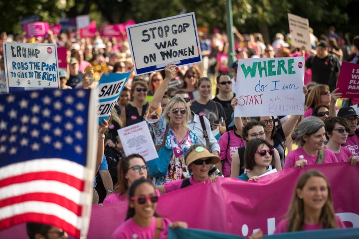 Activists march around the U.S. Capitol to protest the Senate GOP health care bill, on Wednesday. 