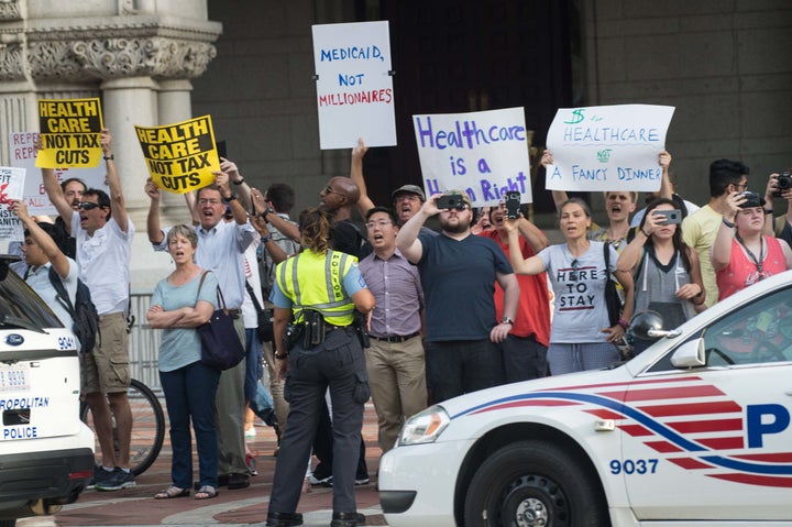 Another sign reads, "Medicaid not millionaires."