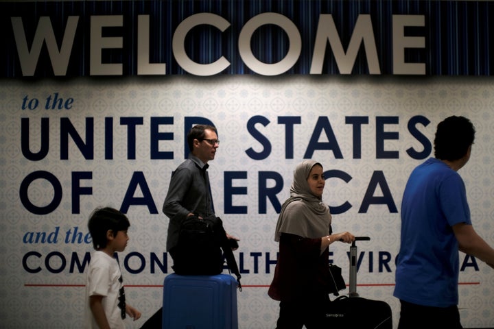 International passengers arrive at Washington Dulles International Airport on Monday, after the U.S. Supreme Court granted parts of the Trump administration's emergency request to put its travel ban into effect later in the week pending further judicial review.