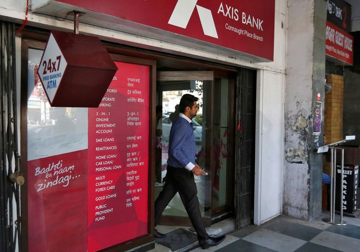 <p> A man leaves an Axis Bank automated teller machine (ATM) in New Delhi, India. </p>