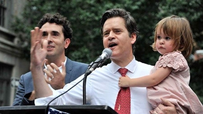 New York state Sen. Brad Hoylman, a Democrat, gives a speech at the Stonewall Inn accompanied by husband David Sigal, and their daughter Silvia, who was carried and delivered by a surrogate. In most states, the law is murky or even silent on surrogacy, but Hoylman hopes to change that in New York.