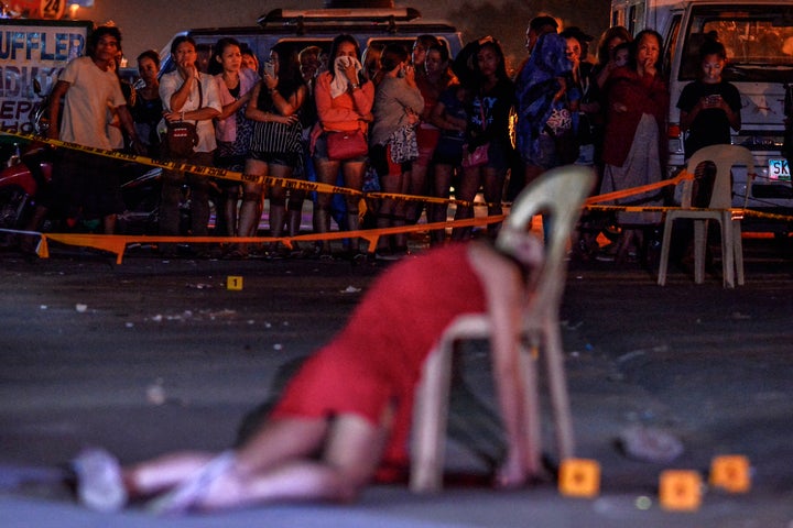 The body of Cristita Padual is slumped on a chair after she was shot dead by unknown assailants in Quezon city, north of Mani