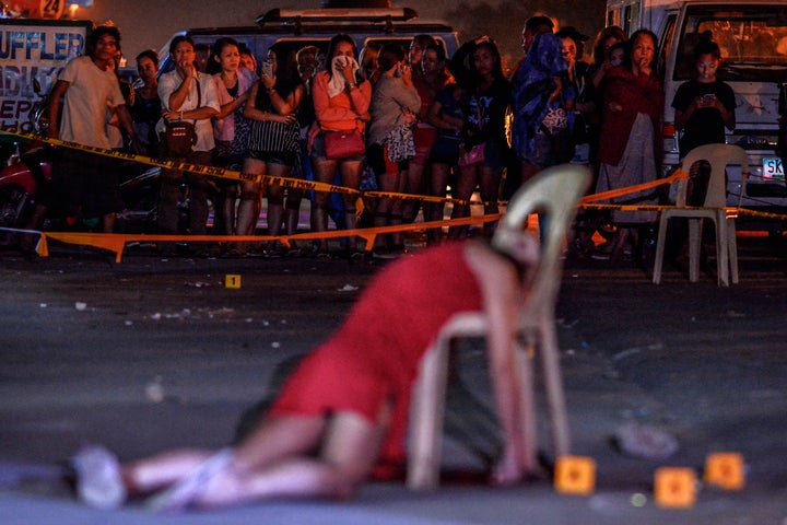 The body of Cristita Padual is slumped on a chair after she was shot dead by unknown assailants in Quezon city, north of Manila.