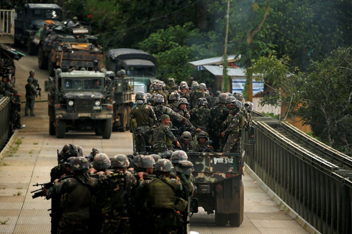 Philippines army soldiers ride in trucks into the fighting zone in the city of Marawi.