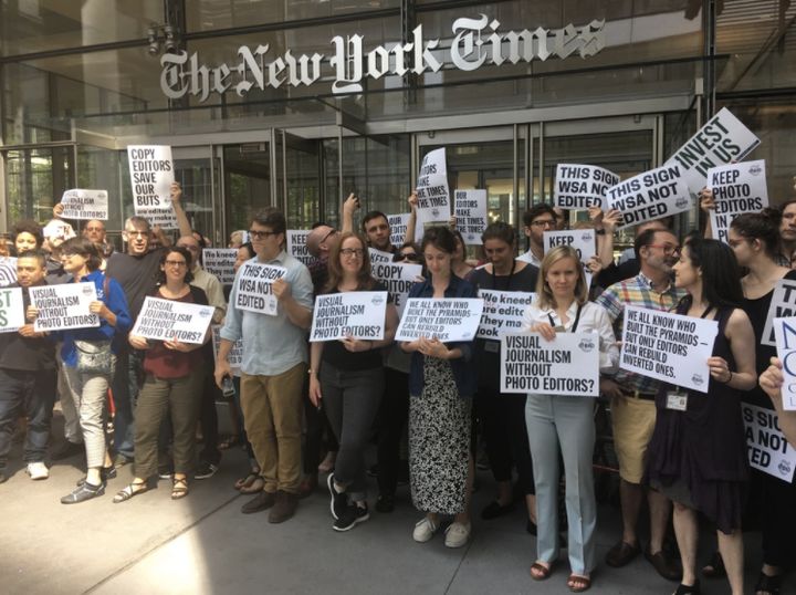 Dozens of New York Times employees stage a walkout after cuts to the publication's copy desk were announced.