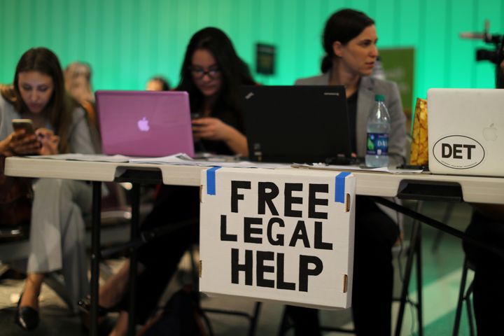 Volunteer lawyers set up tables at U.S. airports to help arriving passengers with the reinstatement of President Trump's travel ban.