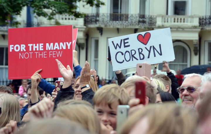 Supporters wave banners as Corbyn addresses a rally in Warrior Square Gardens