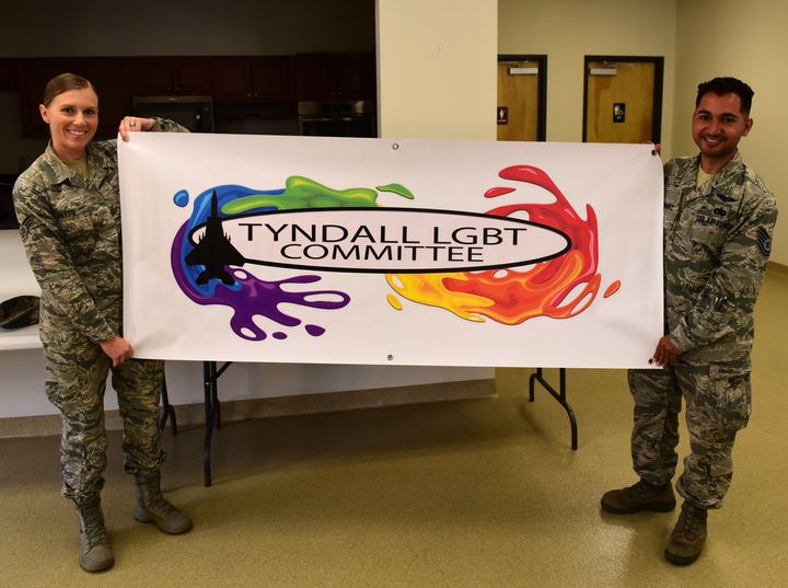 Technical Sgt. Martin Rodriguez (right), 325th Logistics Readiness Squadron Travel Center section chief, and Senior Airman Kayla Betts (left), 325th Medical Group mental health technician, hold up the banner of the Tyndall Lesbian, Gay, Bisexual and Transgender Committee at the Tyndall Air Force Base chapel, June 26, 2017. The LGBT Committee is the first of its kind at Tyndall and was founded to give its members a voice to promote diversity. 