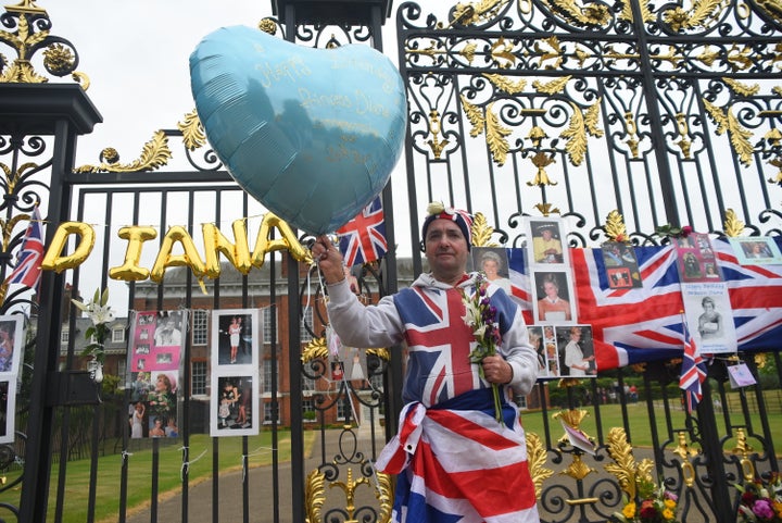 Visitors left balloons, flags and photos at Kensington Palace, where Princess Diana once lived.