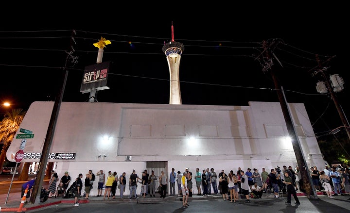 Customers line up in Las Vegas Friday evening as they wait for recreational marijuana sales to begin.