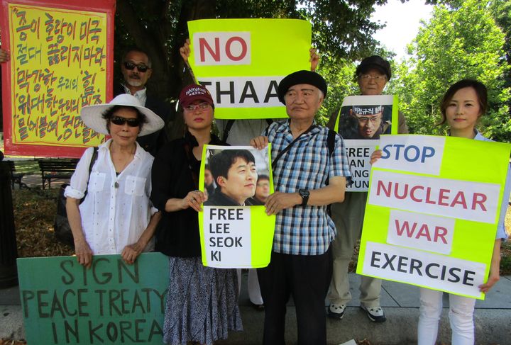 Ji Gephardt [L] and Angie Kim [R] join fellow like-minded protesters during a rally against perceived U.S. militarism in Korea.