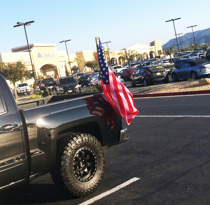 <p>An American flag carried by a pickup truck in Southern California</p>