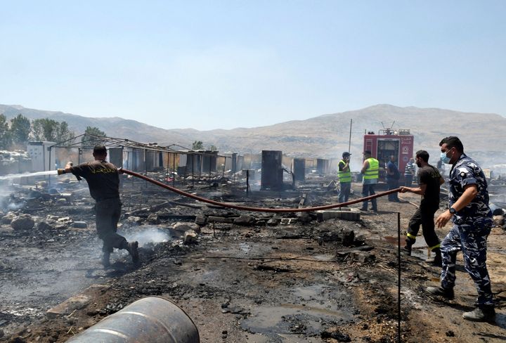 Firefighters put out fire at a camp for Syrian refugees near the town of Qab Elias, in Lebanon's Bekaa Valley. 