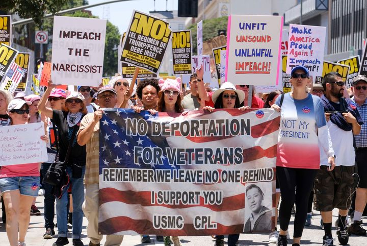 Demonstrators hold signs in Los Angeles.