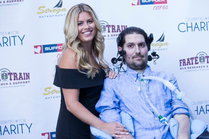 Julie Frates holds her husband, Pete Frates, at a fundraiser during ALS Awareness Month in Boston last August.