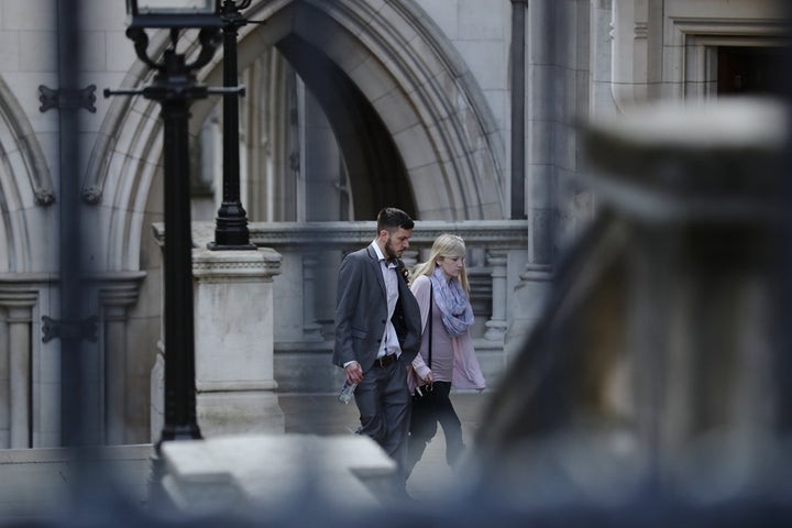 The parents of Charlie Gard, Chris Gard and Connie Yates, walk through the grounds of the Royal Courts of Justice on April 7 in London.