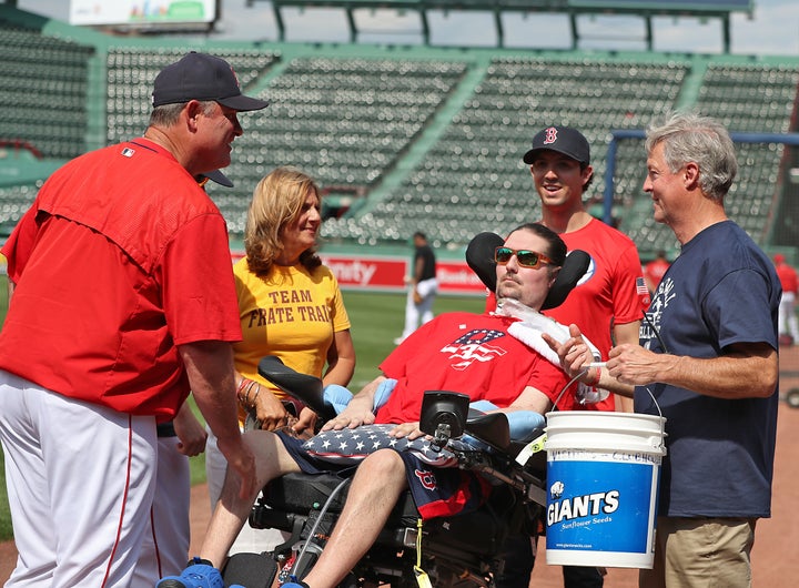 Boston Red Sox manager John Farrell greets Frates and his family at Fenway Park in Boston in June. During his visit, Frates donated some of his belongings to the National Baseball Hall of Fame in Cooperstown, New York.