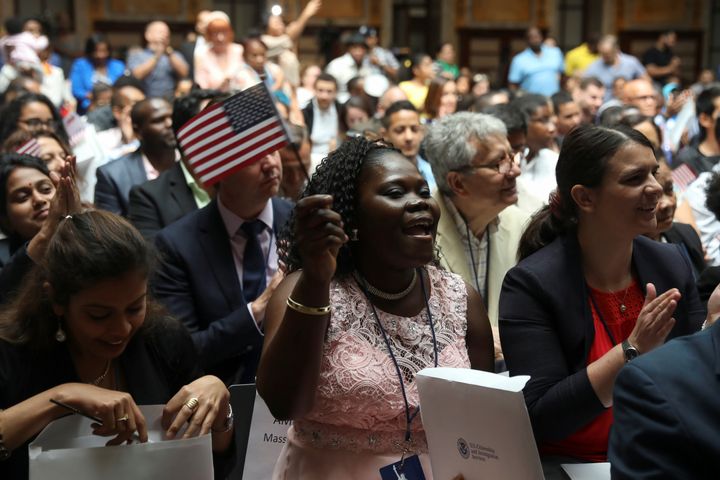 Immigrants smile after receiving their certificates of citizenship at a naturalization ceremony in the New York Public Library on Friday.