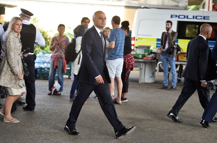 Sajid Javid, pictured visiting the scene of the Grenfell fire, said Corbyn was using the tragedy as a 'political football'