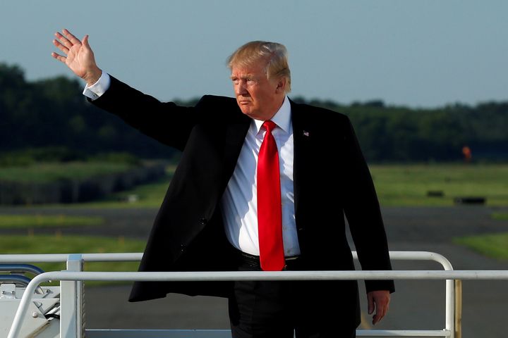 President Donald Trump waves as he boards Air Force One Monday, en route back to Washington after spending most of his weekend at the Trump National Golf Club in Bedminster, N.J.