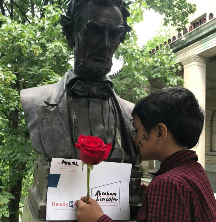 Isaac giving a kiss on the statue of President Abraham Lincoln. 