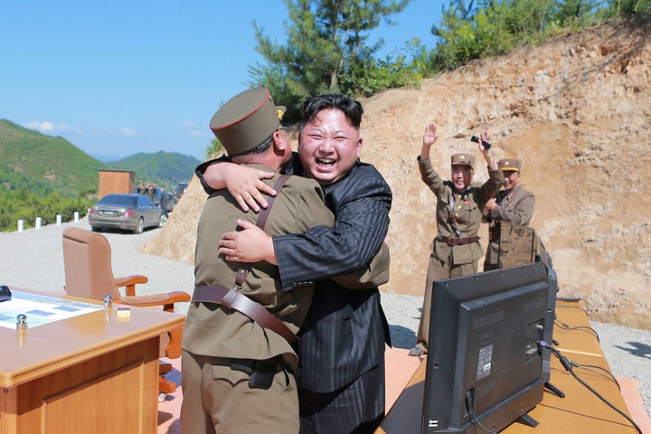 North Korean leader Kim Jong Un reacts with scientists and technicians of the DPRK Academy of Defense Science after the test-launch of the intercontinental ballistic missile.