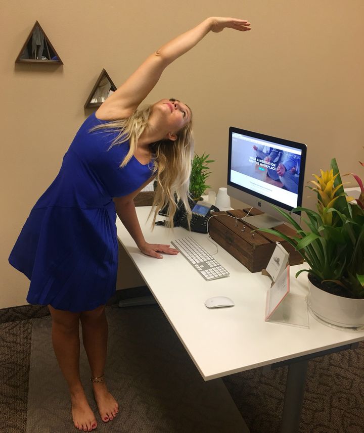 Padgett demonstrates a desk yoga pose