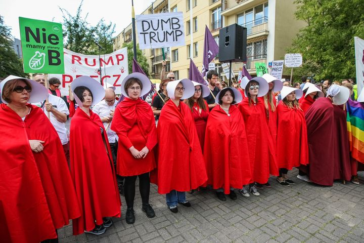 Handmaids lined up to greet President Trump. 