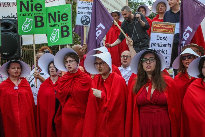 Protestors dressed as handmaids in Warsaw.