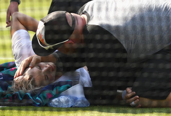 Bethanie Mattek-Sands receives treatment from the medical team on day four of the Wimbledon Lawn Tennis Championships at the