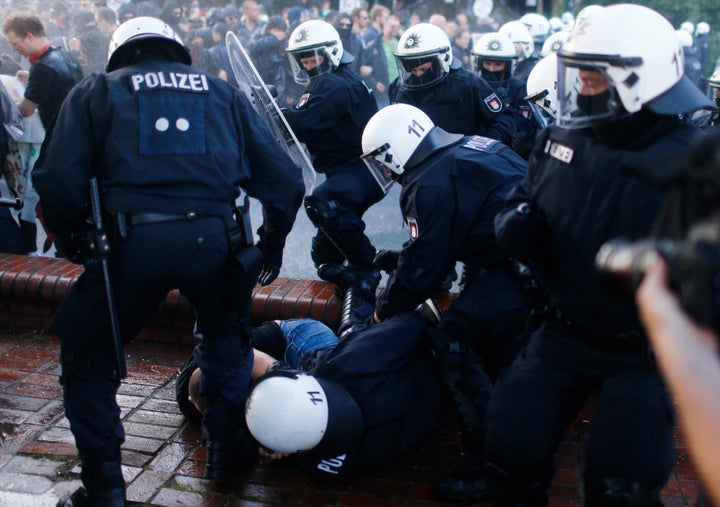 German riot police detain a protester during the demonstrations at the G-20 summit in Hamburg, Germany.