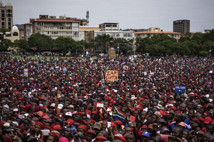 A protester holds a placard reading 'Zap Zupta', referring to Zuma and the Gupta Family in the capital Pretoria in April