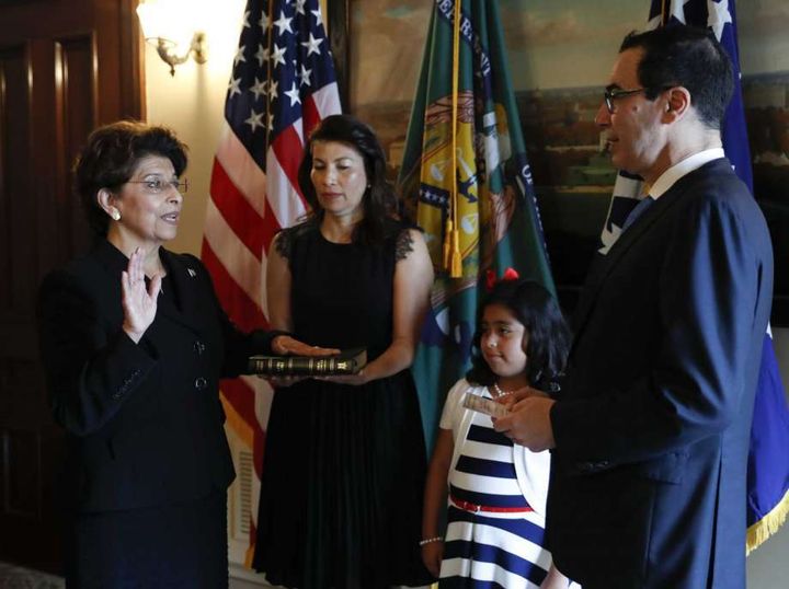 Treasury Secretary Steven Mnuchin, right, administer the oath of office to Jovita Carranza.