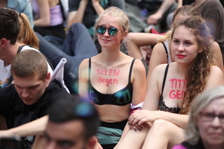 Young women in Hamburg have written 'Tits against G20' on their chest in protest 