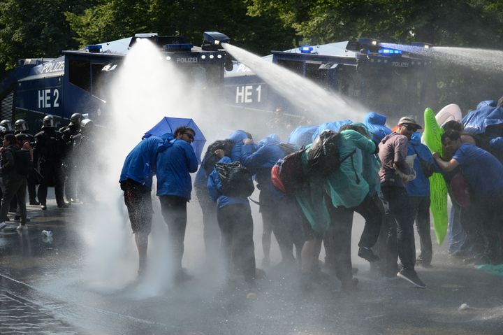 Demonstrators are hit by water cannons during protests on Friday 