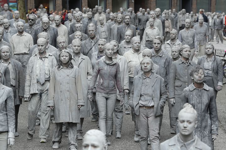 Performance artists covered themselves in clay in a 'public appeal for humanity' 