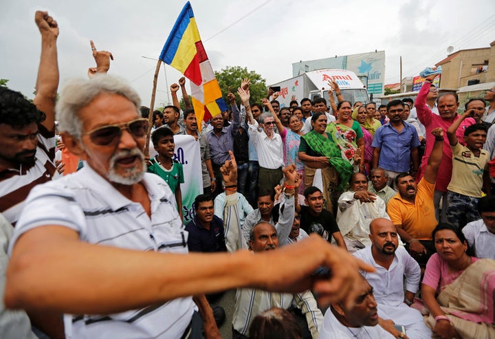 Low-caste community shout slogans after four men accused of skinning a cow were flogged in Gujarat, 2016