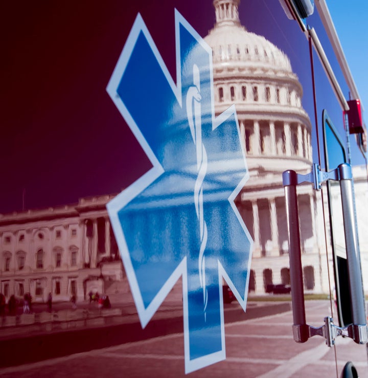 UNITED STATES – JUNE 26: The U.S. Capitol is seen in a reflection on the side of an ambulance in Washington on Monday, June