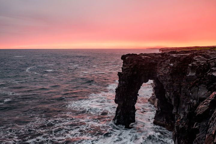 The Hōlei Sea Arch warmed at sunset.