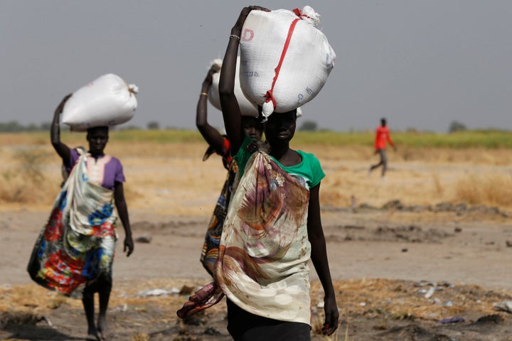 Women carry sacks of food in Nimini village, Unity State, in northern South Sudan, on Feb. 8, 2017.