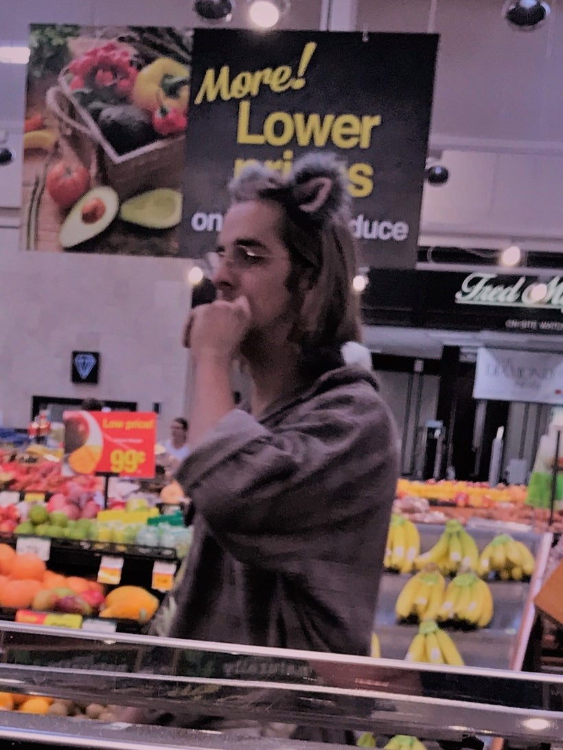 Adult who self-identifies as a rat with “service rats” on shoulder in grocery store.