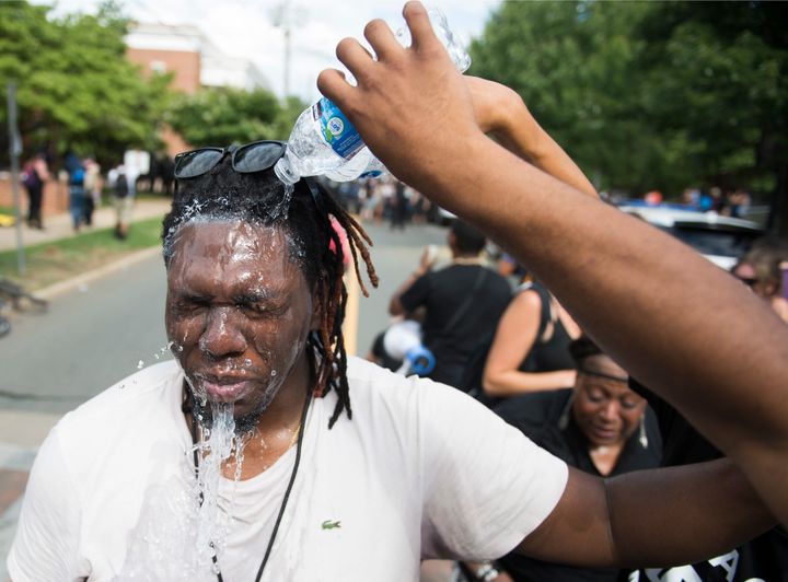 A protester has his eyes washed after being tear gassed by police.