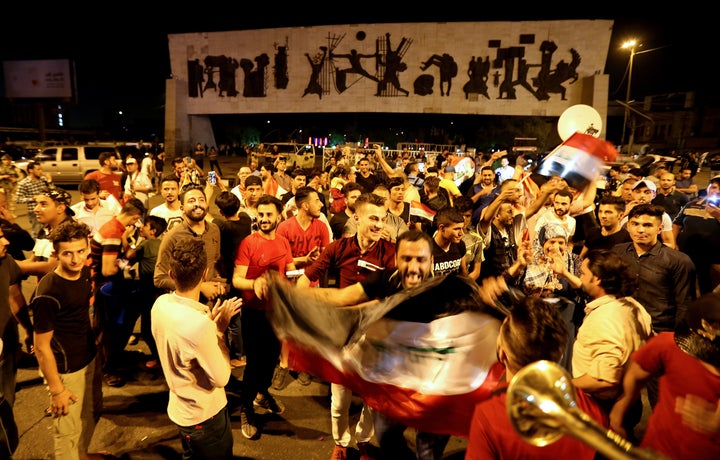 Iraqis gather and dance at the Tahrir Square in the capital Baghdad on July 9, 2017 to celebrate the government's announcemen